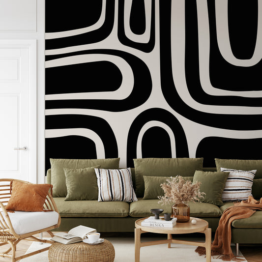 a living room filled with furniture and a large wall mural