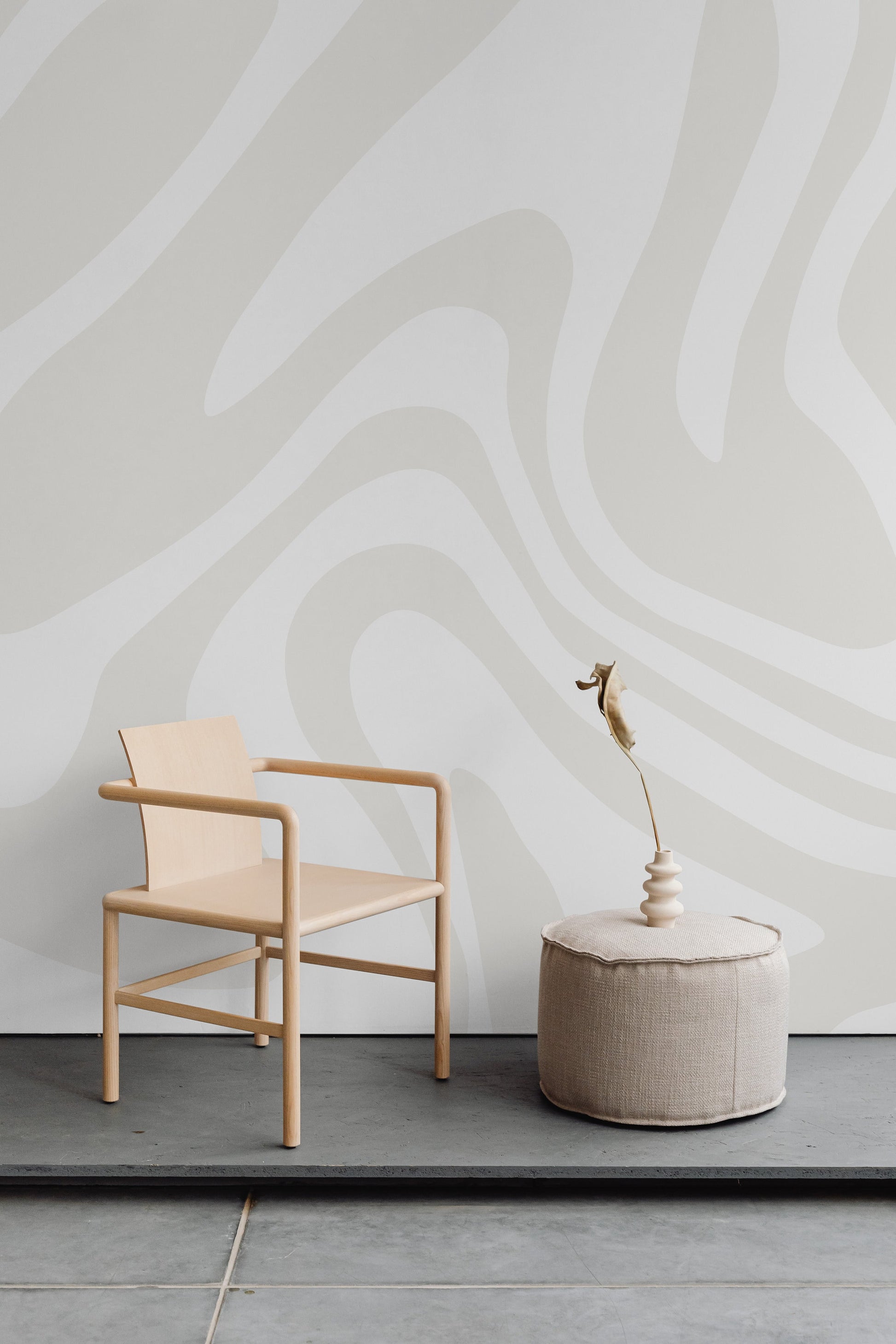 a chair and a table in front of a wall