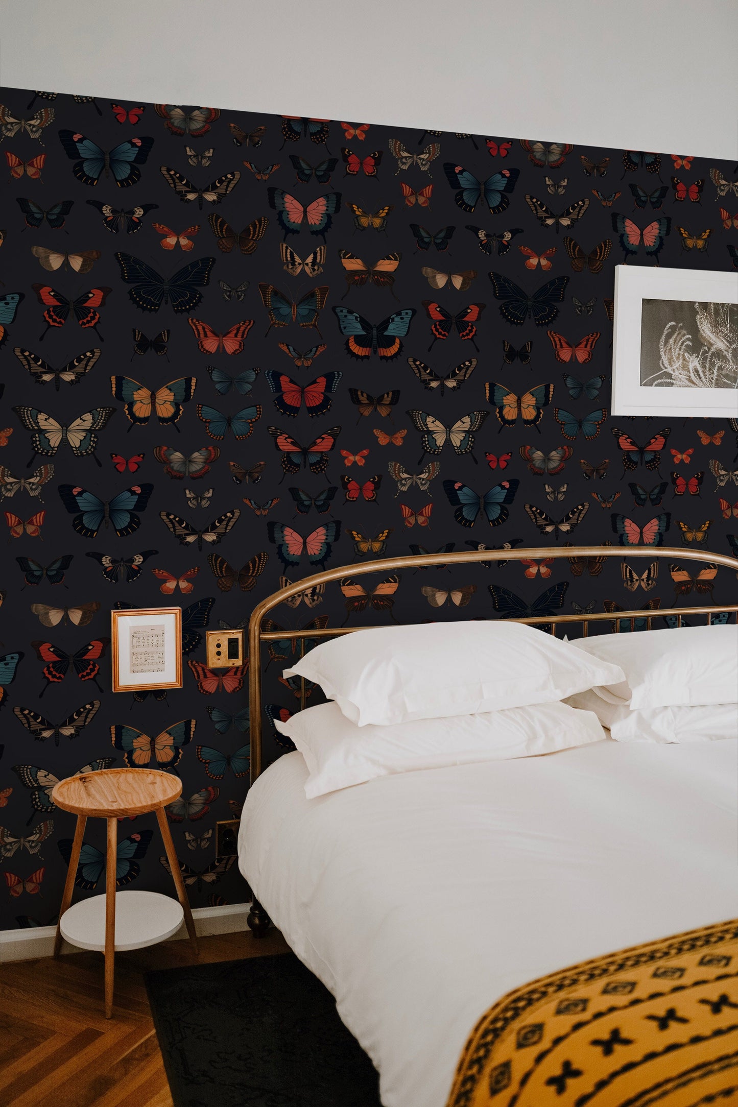 a bed in a bedroom with a black wallpaper